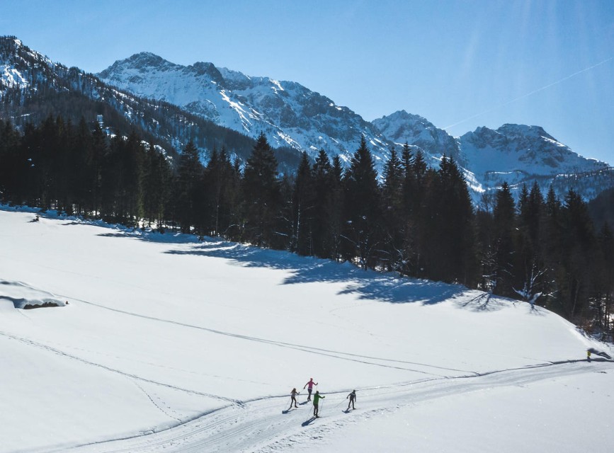 Langläufer auf einer Loipe direkt ab dem Familienhotel Botenwirt mit Blick auf die verschneiten Berge © Wagrain-Kleinarl Tourismus/Christian Schartner