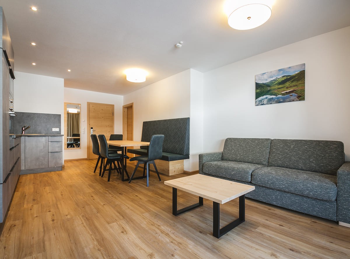 Modern apartment in the family hotel Botenwirt with a cozy double bed and balcony view of the mountains from Kleinarl Valley