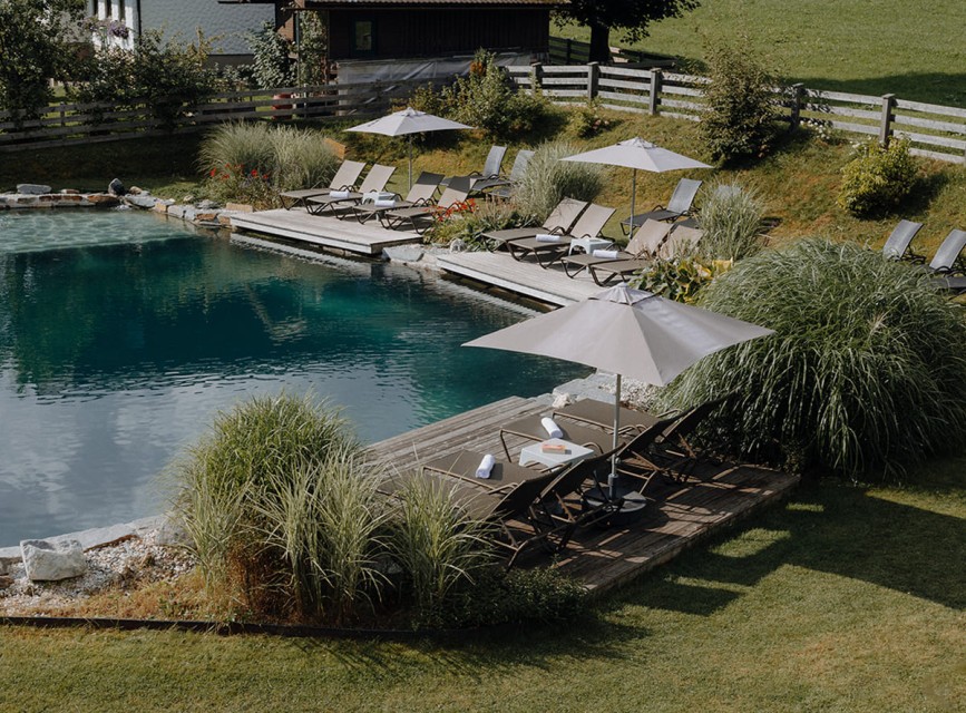 Natural swimming pond with cozy loungers &ndash; summer idyll at the family hotel Botenwirt